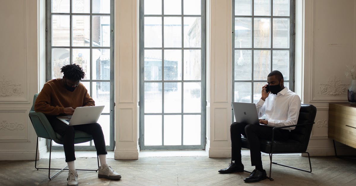 1.9 Executing as AreaEffectClouds - Black businessman speaking on smartphone against partner working on laptop