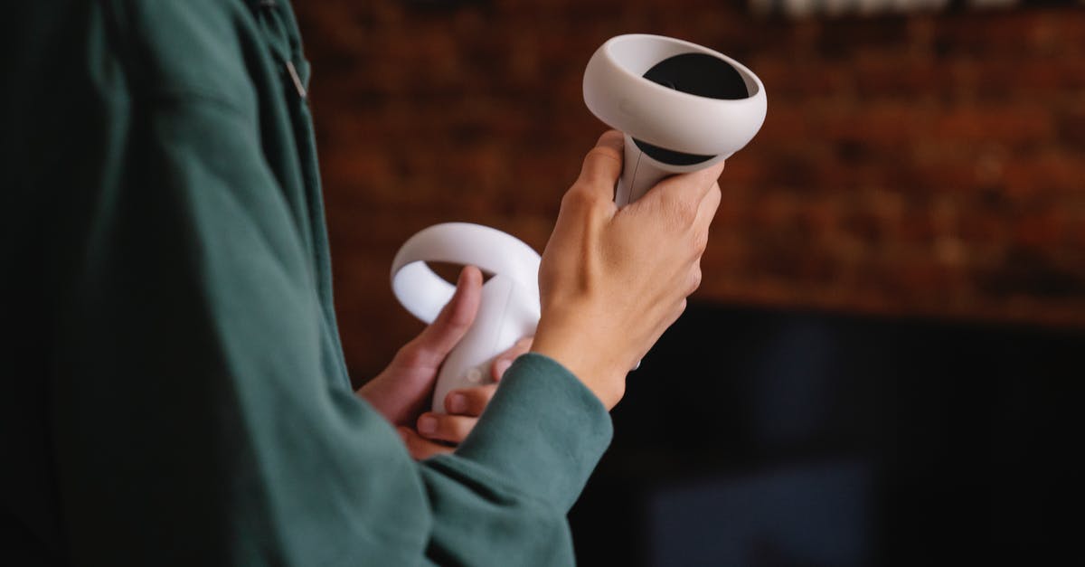 360 controller sticking in 3rd person view - Side view of crop anonymous person with virtual reality controllers playing video game at home in daylight 360 controller sticking in 3rd person view - Side view of crop anonymous person with virtual reality controllers playing video game at home in daylight