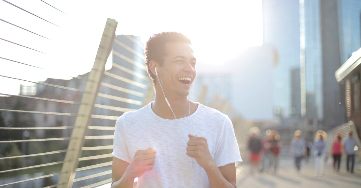 'hl2.exe has stopped working' when I run demos - Low angle of young African American man in earphones and white shirt looking away with interest and laughing while running alone along street and listening to music against blurred high rise buildings in downtown 'hl2.exe has stopped working' when I run demos - Low angle of young African American man in earphones and white shirt looking away with interest and laughing while running alone along street and listening to music against blurred high rise buildings in downtown