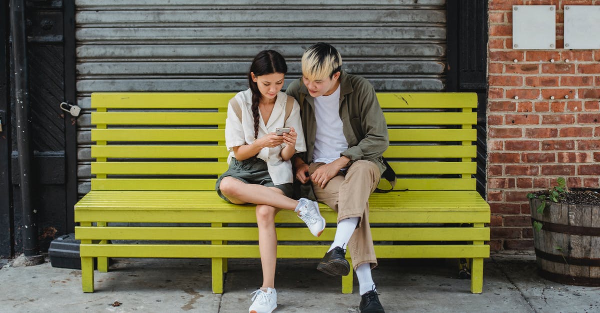 3DS Friend Registration: "You cannot use Internet registration because you are not online". How to fix? - Serious multiracial couple resting on yellow bench and browsing smartphone and looking at screen 3DS Friend Registration: "You cannot use Internet registration because you are not online". How to fix? - Serious multiracial couple resting on yellow bench and browsing smartphone and looking at screen