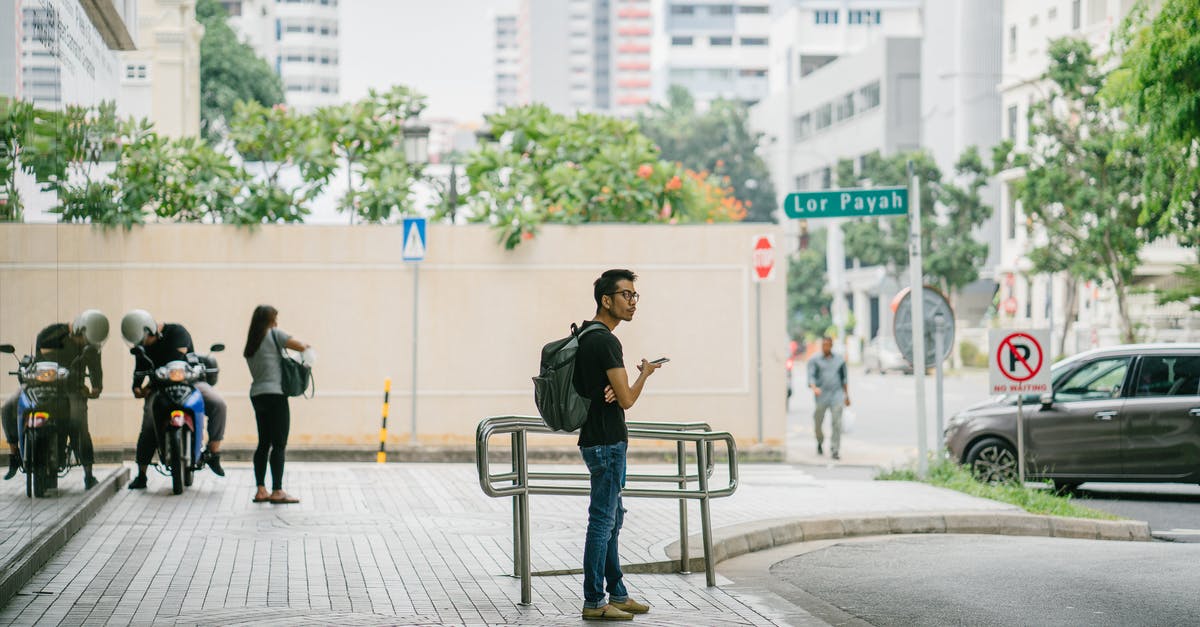 7 days after mobile authentication, still getting 15 day hold. - Man Carrying Backpack