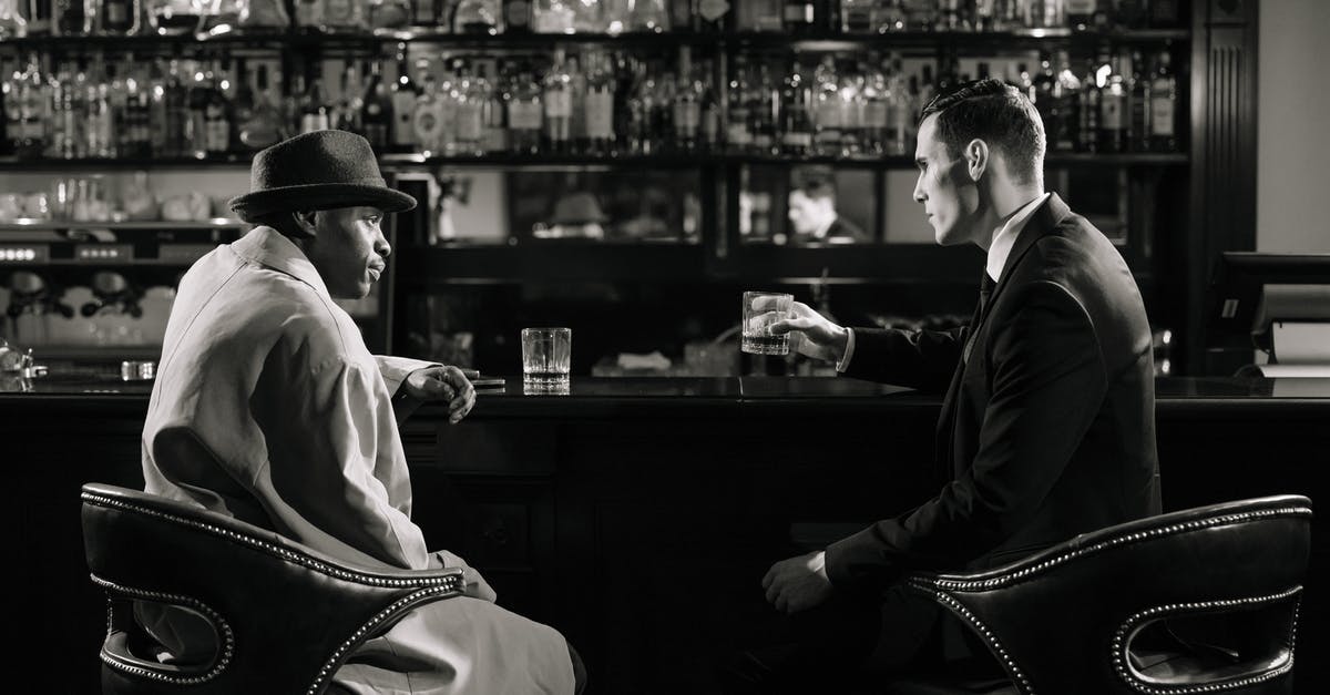 A decent starting weapon for an explosives/sneaky character on the very hard difficulty level? - Monochrome Photo of Men Sitting in Front of Bar Counter