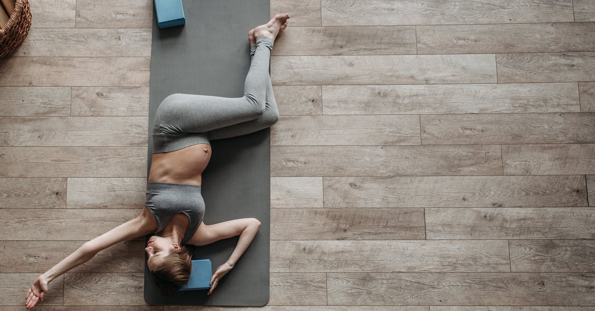 A pregnancy in a full vault? - A Pregnant Woman in Gray Activewear Exercising at Home A pregnancy in a full vault? - A Pregnant Woman in Gray Activewear Exercising at Home