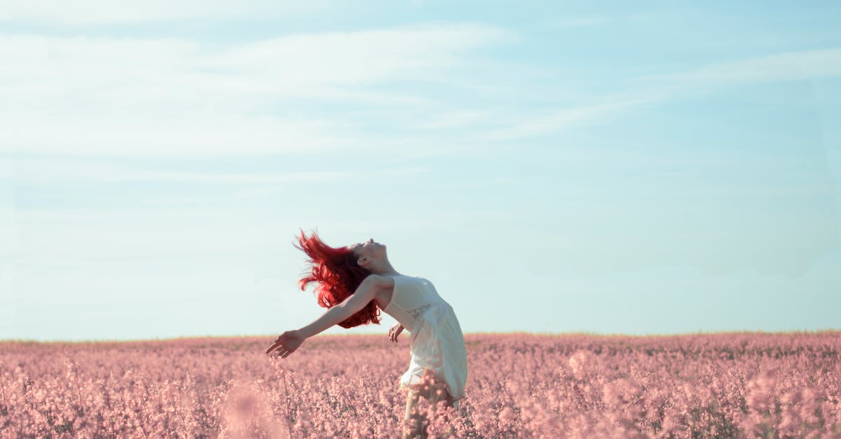 Abandon leads to invulnerable hero - Woman in Yellow Dress Standing on Pink Petaled Flower Field