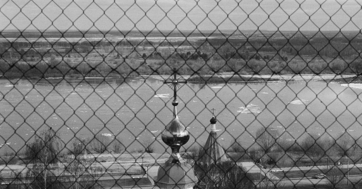 About advent security towers - Mesh Wire Fence Near the Church Towers About advent security towers - Mesh Wire Fence Near the Church Towers