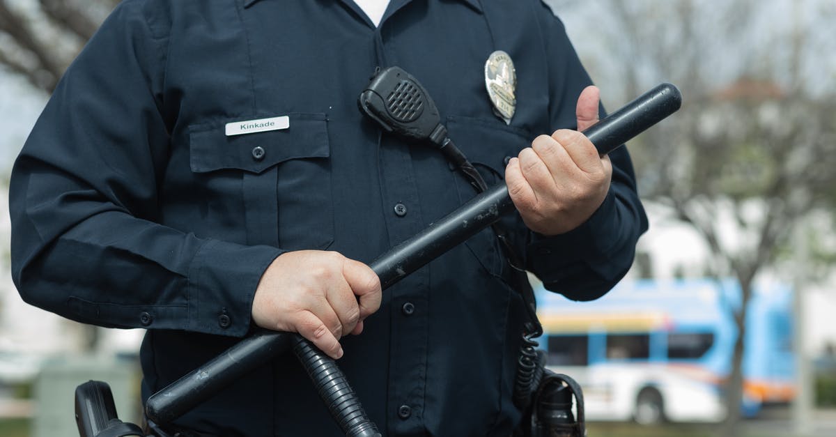 About advent security towers - Man in Black Police Uniform Holding Black Metal Rod