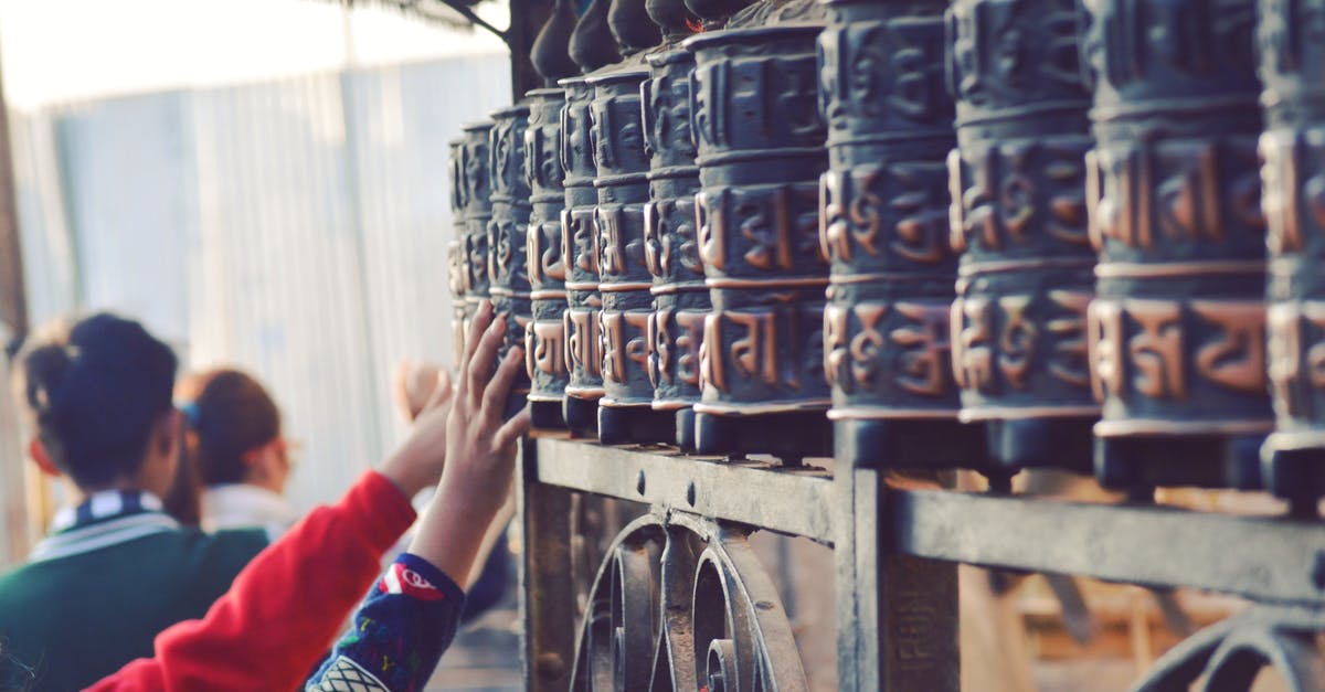 Accedently substituted my clash of clans village with a new one while trying to connect. How do i get my old village back? - Back view of anonymous tourists touching old metal Prayer wheels with hieroglyphs above ornamental fence near old Buddhist temple in Swayambhunath Accedently substituted my clash of clans village with a new one while trying to connect. How do i get my old village back? - Back view of anonymous tourists touching old metal Prayer wheels with hieroglyphs above ornamental fence near old Buddhist temple in Swayambhunath