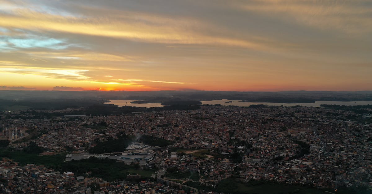 Accessing certain Ziost areas - Picturesque cityscape under cloudy sky on sundown Accessing certain Ziost areas - Picturesque cityscape under cloudy sky on sundown