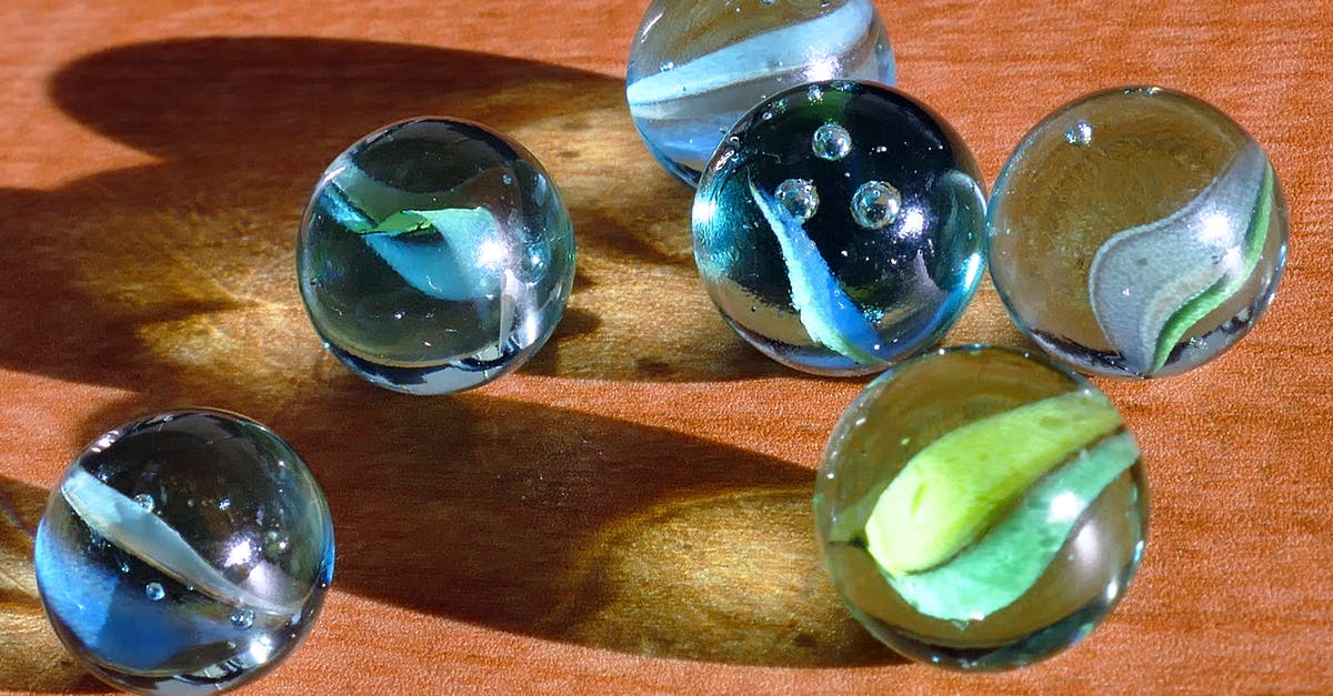Accidentally trashed my poke balls and incense, how do I recover discarded items? - Six Blue and Green Marbles on Brown Surface