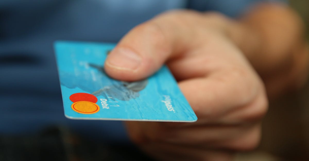 Account login and transfer items [duplicate] - Person Holding Debit Card