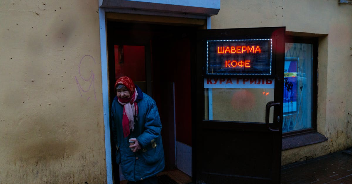 Age rating for Town of Salem? - Senior gloomy female in shawl and warm jacket with cup of coffee leaning on entrance of bistro and looking at camera Age rating for Town of Salem? - Senior gloomy female in shawl and warm jacket with cup of coffee leaning on entrance of bistro and looking at camera