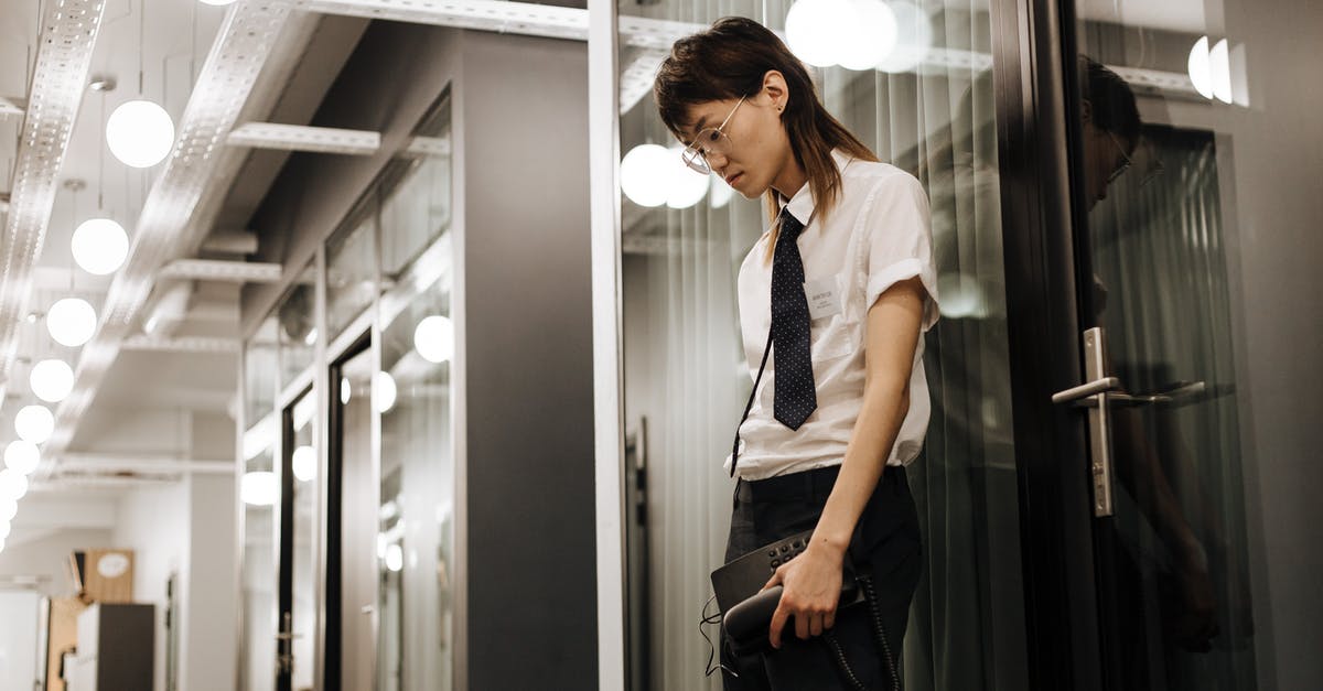 Agent A: Lightbulb and a Hammer - A Stressed Looking Man Leaning on a Glass Panel while Holding a Telephone Agent A: Lightbulb and a Hammer - A Stressed Looking Man Leaning on a Glass Panel while Holding a Telephone