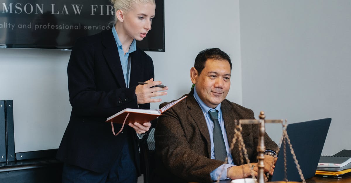 Aging strategy in Forge of Empires - Ethnic male lawyer showing document on laptop to young female colleague