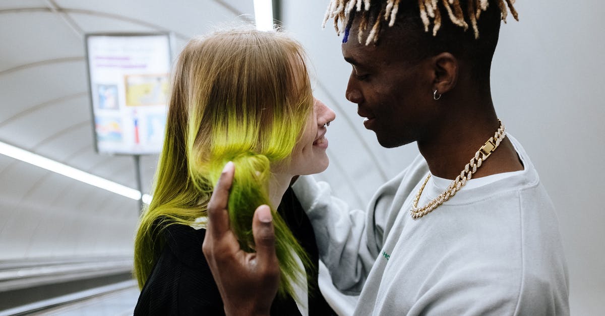 Am I able to log on to the same profile on two consoles? - Man in White Dress Shirt Beside Woman in Black Blazer