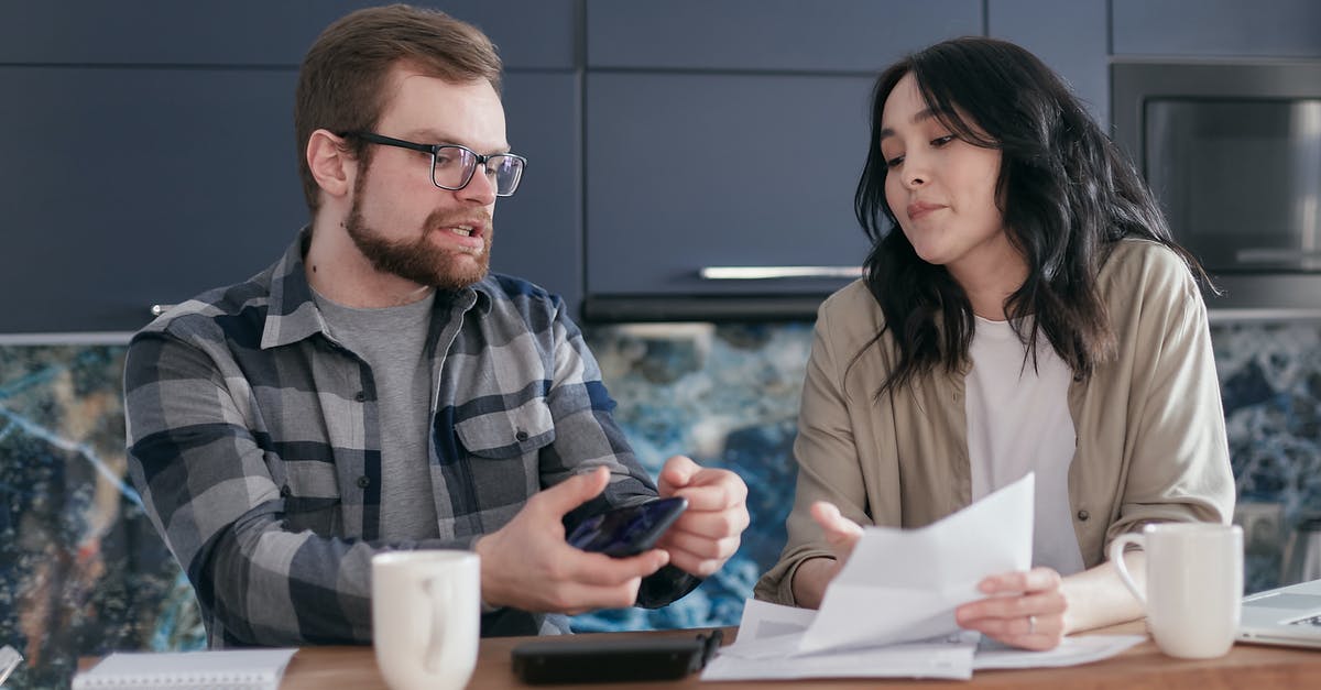 Am I in perpetual debt to Tom Nook? - Man and Woman Sitting at Table