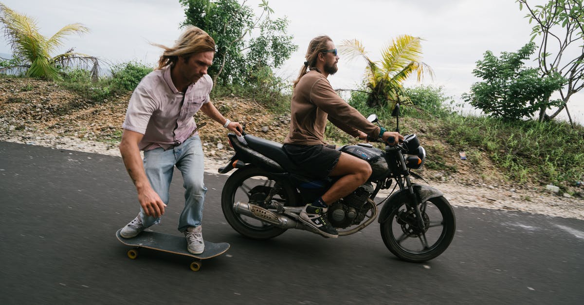 Am I required to pull off crazy Golden Cookie combos? - Man balancing on skateboard while being pulled by biker