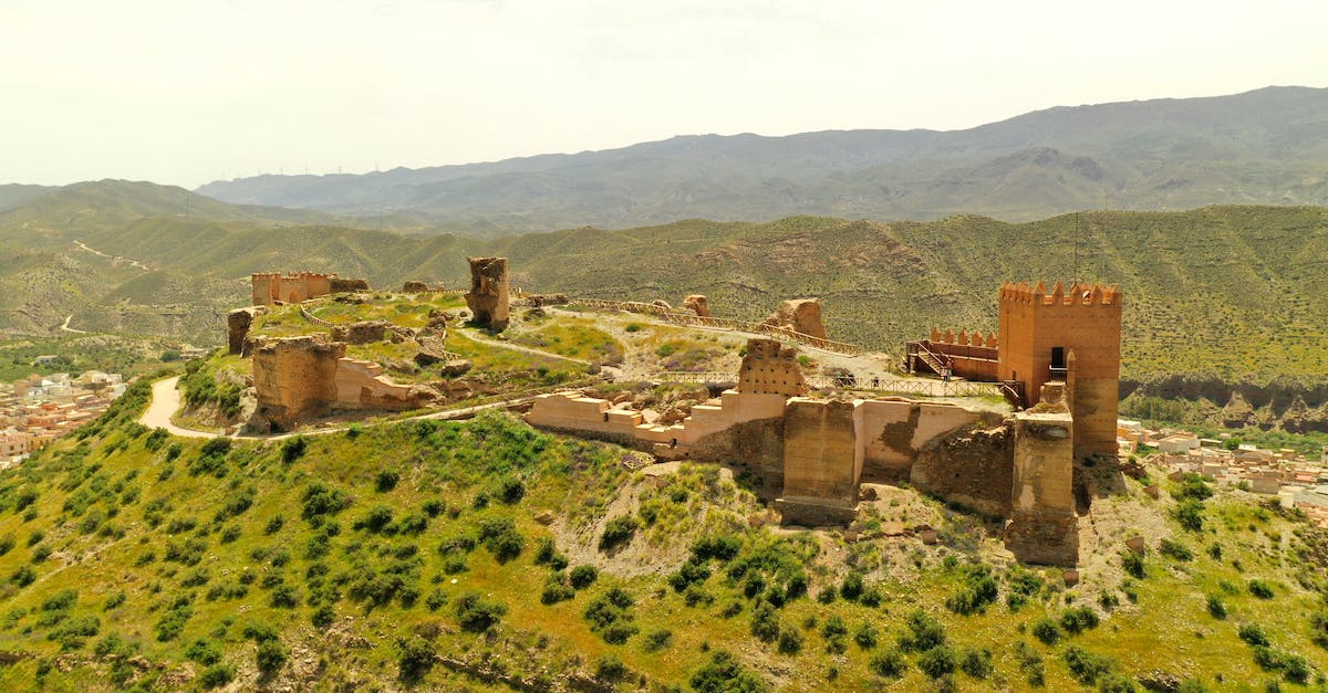 An unbeatable fortress of a singe vampire? - Brown Concrete Building on Top of Mountain