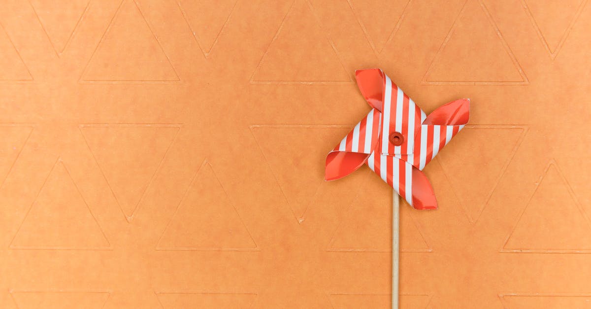 Android game showing a roboter on a windmill (which is built with Minecraft-like blocks) - Red and White Pinwheel on Brown Surface Android game showing a roboter on a windmill (which is built with Minecraft-like blocks) - Red and White Pinwheel on Brown Surface