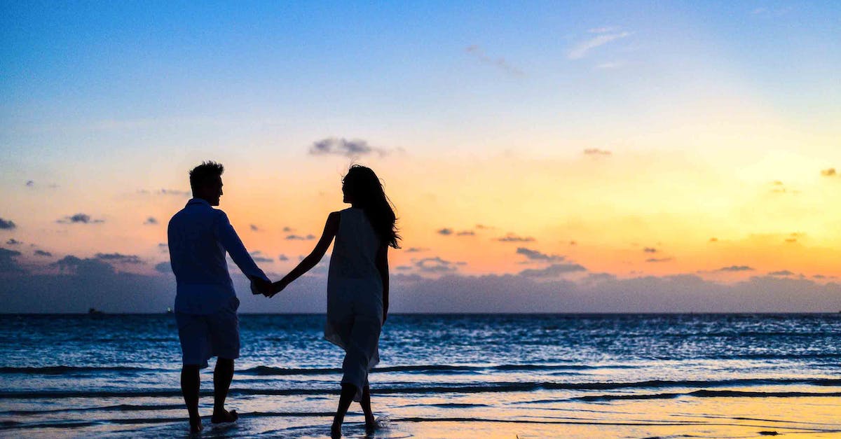Anniversary XP bonus boost - Man and Woman Holding Hands Walking on Seashore during Sunrise