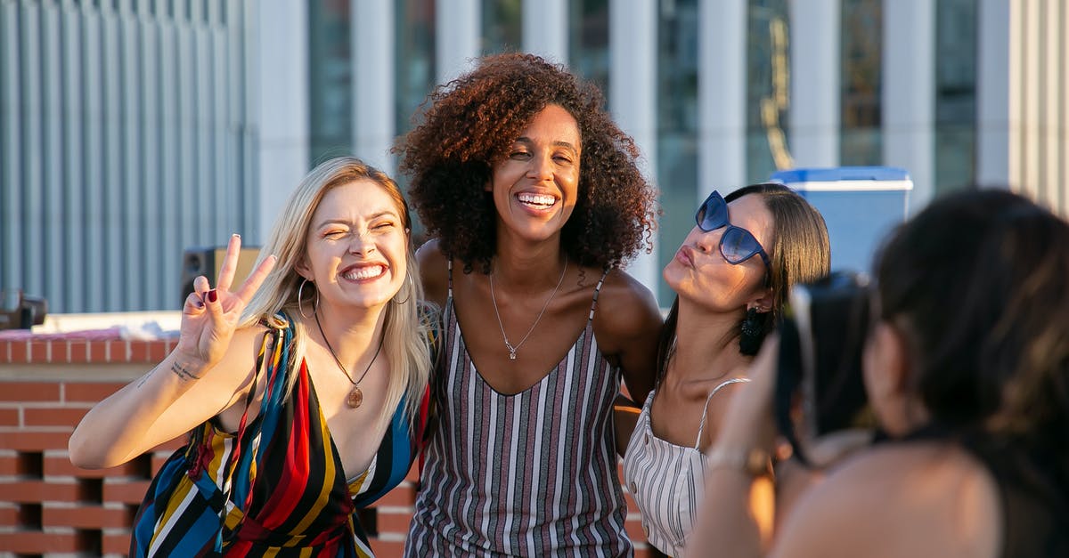 Any use to building up relationship with non party members? - Unrecognizable female photographer taking picture of cheerful young multiracial female friends smiling and showing V sign during party on modern building rooftop Any use to building up relationship with non party members? - Unrecognizable female photographer taking picture of cheerful young multiracial female friends smiling and showing V sign during party on modern building rooftop