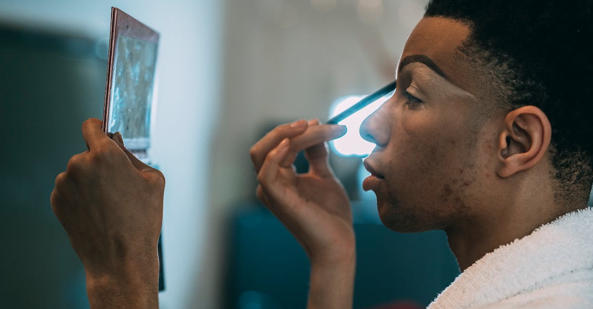 Applied Energistics Subnetwork doesn't accept items - Side view of serious African American feminine male applying eyeshadow on eyelid while looking into mirror in dressing room on blurred background Applied Energistics Subnetwork doesn't accept items - Side view of serious African American feminine male applying eyeshadow on eyelid while looking into mirror in dressing room on blurred background