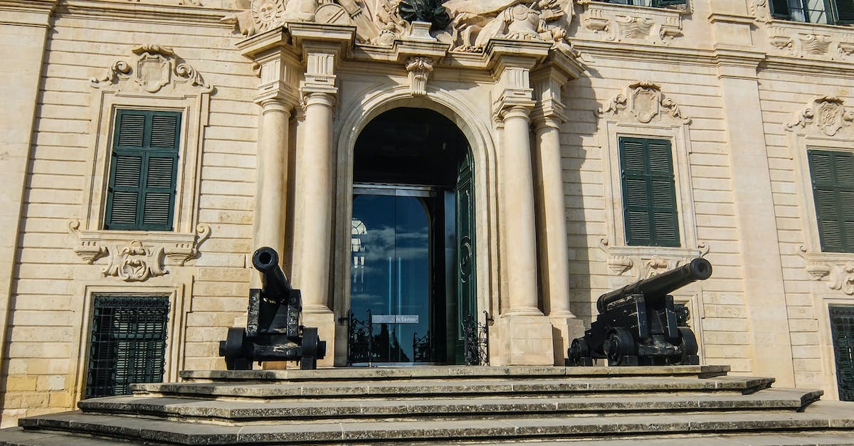 Are Blackheart's cannons random? - Two Black Cannons Decor in Front of White Concrete Building
