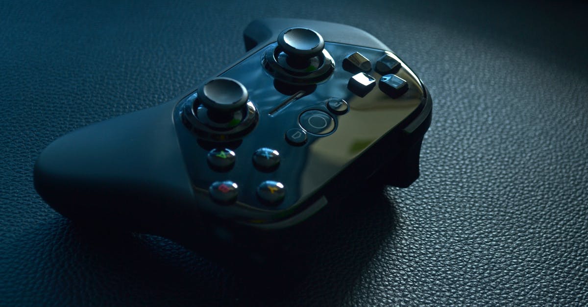 Are DPI control buttons considered cheating for e-sports tournaments? - Black Wireless Game Controller on Black Leather
