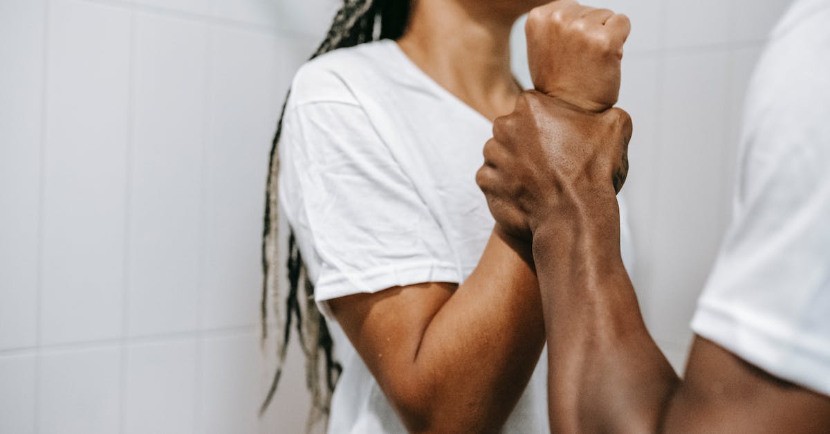Are Endermen afraid of certain enchantments? - Side view of crop unrecognizable aggressive African American male holding wrist of scared wife while quarreling together in bathroom