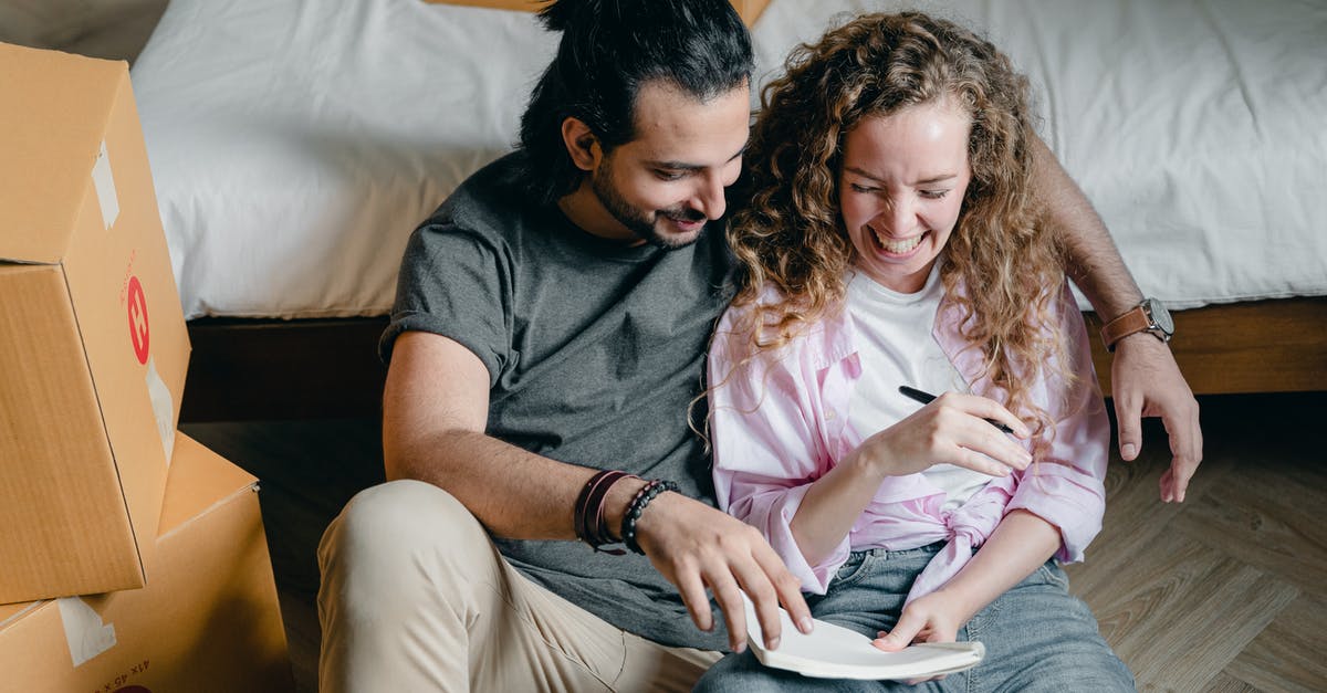 Are Memory Crystals new? - Cheerful couple with notebook moving house