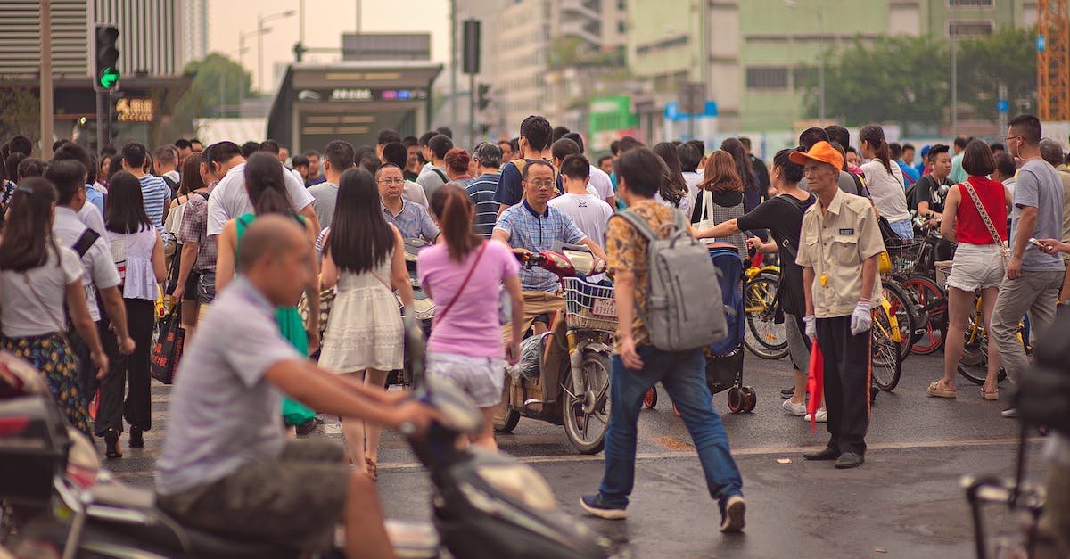 Are pedestrian walkways purely cosmetic, or do they help encourage walking instead of driving? - Unrecognizable Asian citizens walking on urban pavement