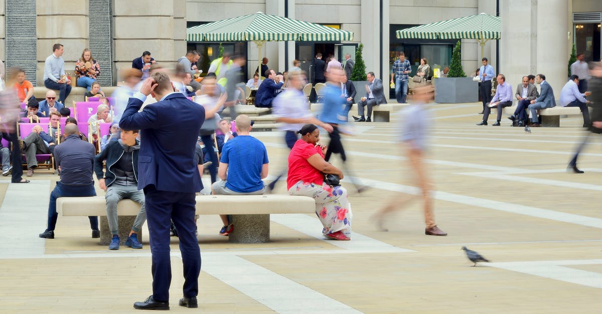 Are Pokemon's moving or standing where they spawned in map-mode? - Man Wearing Blue Suit on Beige Ground Near Building