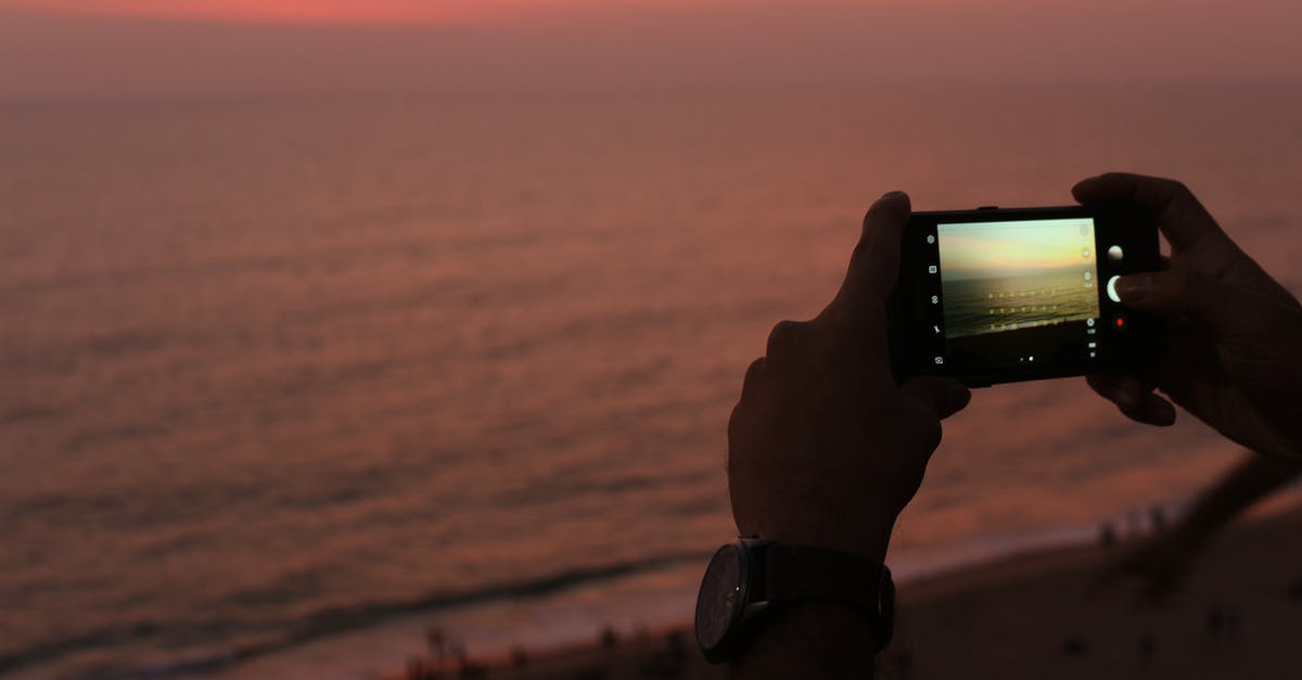 Are "bots" that only observe the screen allowed? - High angle of crop anonymous male traveler using smartphone while taking photo of amazing sunset over waving ocean standing above sandy beach Are "bots" that only observe the screen allowed? - High angle of crop anonymous male traveler using smartphone while taking photo of amazing sunset over waving ocean standing above sandy beach