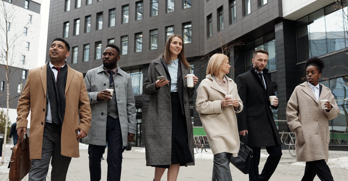 Are synthetic leaders immortal? - Coworkers Taking a Coffee Break and Walking