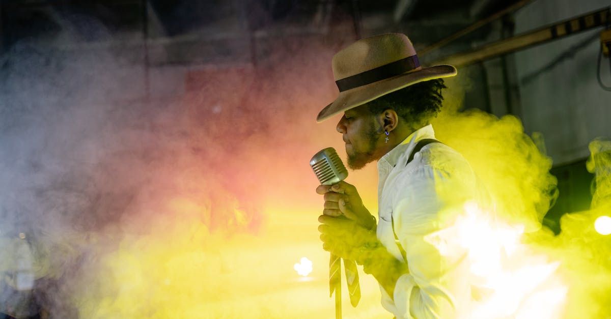 Are the effects granted by the TI Compendium permanent? - Man in Yellow Dress Shirt and Brown Hat Holding Microphone