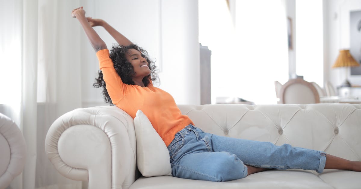 Are the live games casted in real time or is there a 2 min delay? [closed] - Happy African American female stretching on sofa
