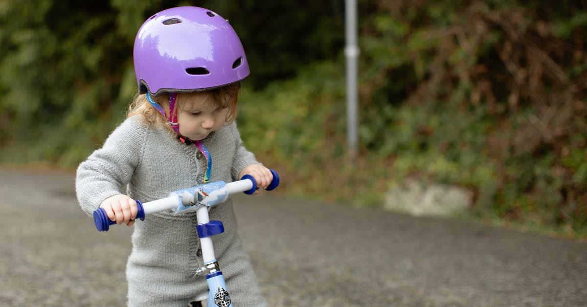 Are the path bonuses offered on a per save file or game basis? - Cute toddler child wearing protective helmet and warm bodysuit playing with bicycle on road near green plants on rural street