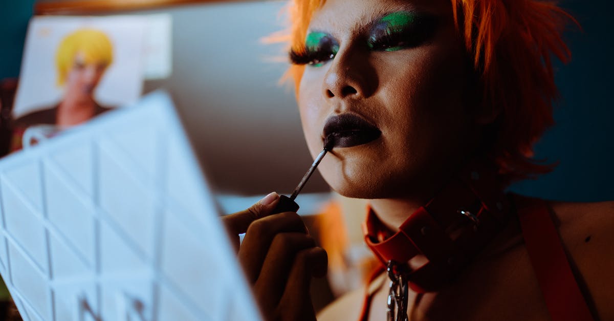 Are there any character effects for having no/low [HIDDEN STAT] - Low angle of crop ethnic eccentric transgender guy with bright makeup in wig and leather collar applying dark lipstick while preparing for performance in nightclub