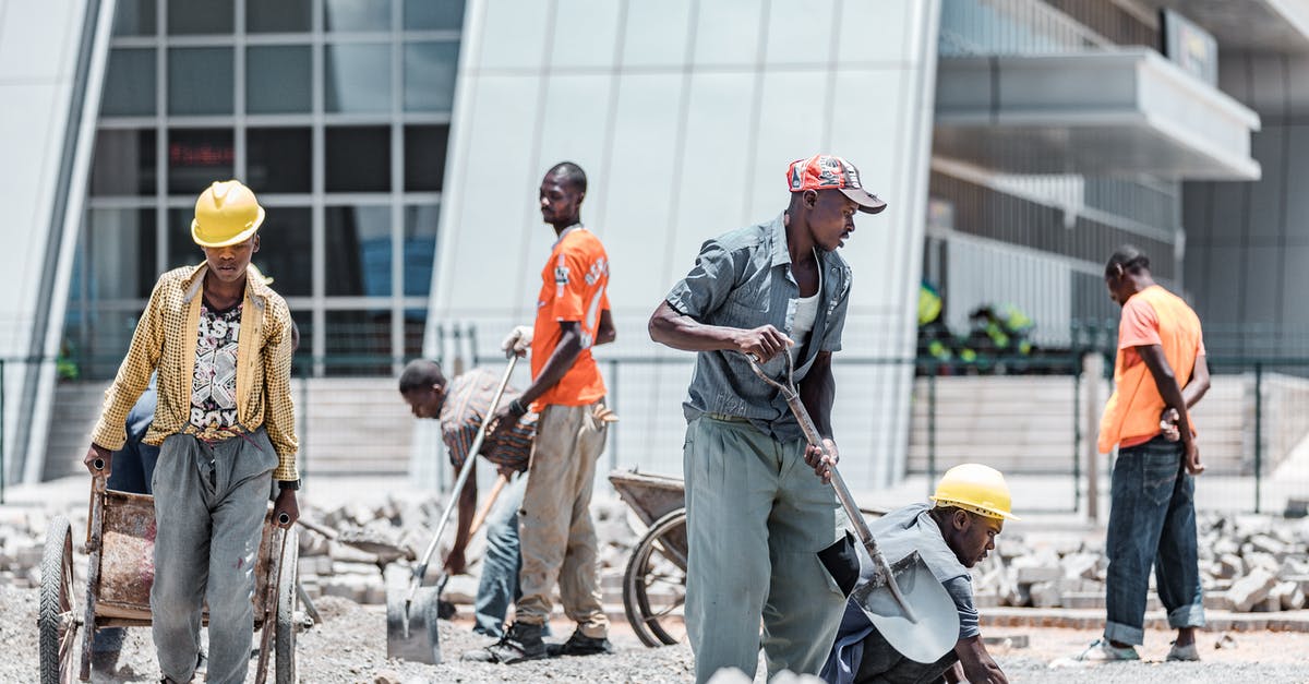 Are there any dangers in working outside in a storm? - Men Working in Construction Outside