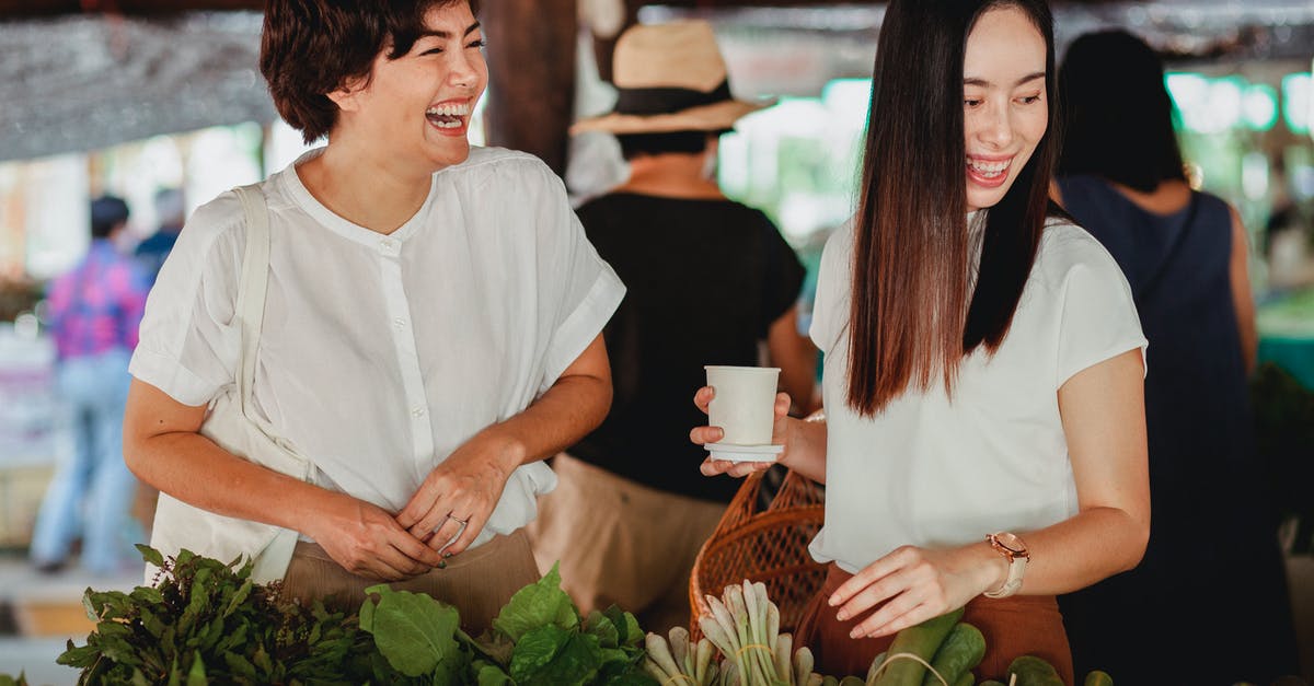 Are there any different endings to Emily Is Away? - Cheerful Asian female friends picking fresh exotic greenery at oriental street store while laughing together Are there any different endings to Emily Is Away? - Cheerful Asian female friends picking fresh exotic greenery at oriental street store while laughing together