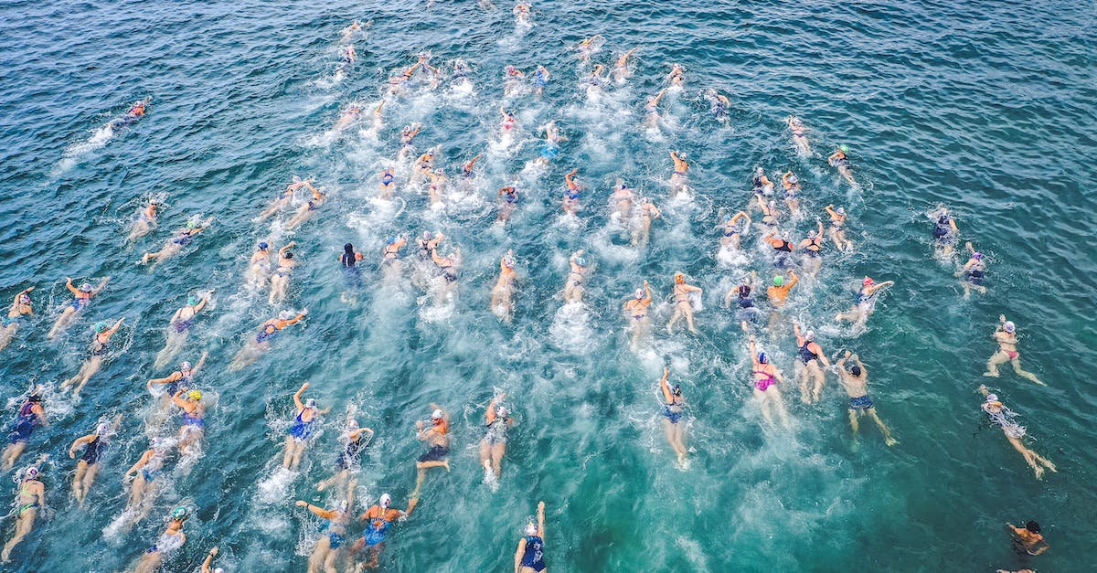Are there any functions of collecting Lums when doing race challenges? - Aerial view of challenge participants in swimsuits swimming forward in splashing clear water