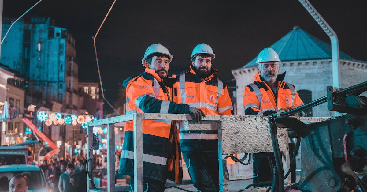 Are there any good Salarian Engineer Specs.? - Man in Orange and Blue Jacket Standing Beside Man in Blue and White Jacket Are there any good Salarian Engineer Specs.? - Man in Orange and Blue Jacket Standing Beside Man in Blue and White Jacket
