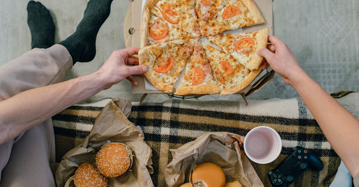 Are there any hints for getting Gold Skulltulas on hard? - Person Holding Pizza on White Ceramic Plate