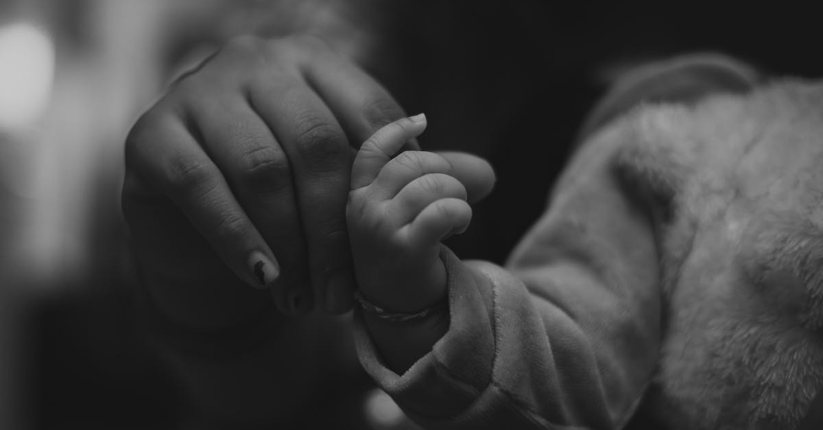 Are there any Minecraft username generators for available names? - Grayscale Photo of Person Holding Babys Hand