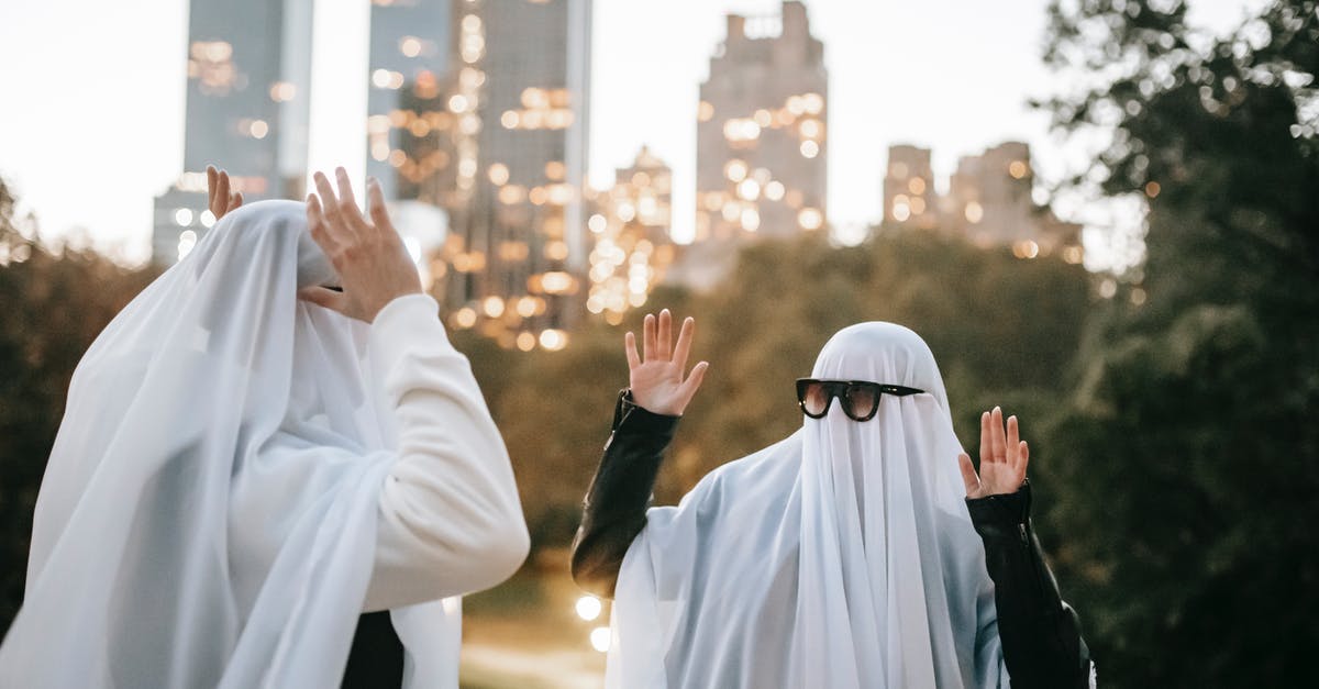 Are there any other minigames besides Funky Bus? - Funny unrecognizable couple with raised arms wearing ghost costumes and sunglasses looking at each other while standing in park with glowing skyscrapers on blurred background during Halloween
