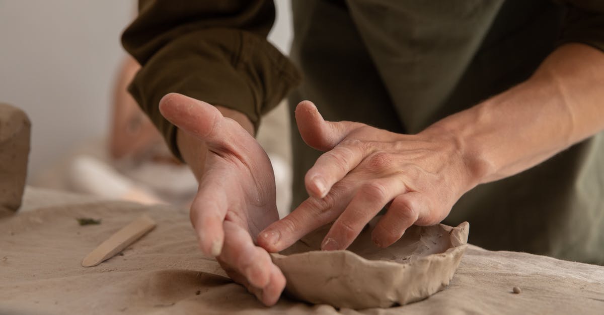 Are there any physics differences between styles in Mario Maker - Crop unrecognizable male artisan in casual clothes sculpting from clay while working in creative studio in daytime