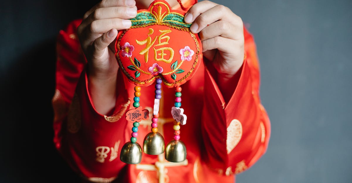 Are there any requirements to spawn the Lord of Bells rift guardian? - Close up of a Child Wearing Red Traditional Clothes Holding Chinese New Year Decoration