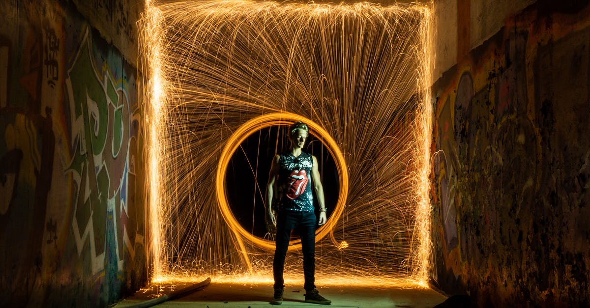Are there any sure-fire ways to beat Round 100 on Deflation mode? - Man standing against lines of light in circle from fire swing