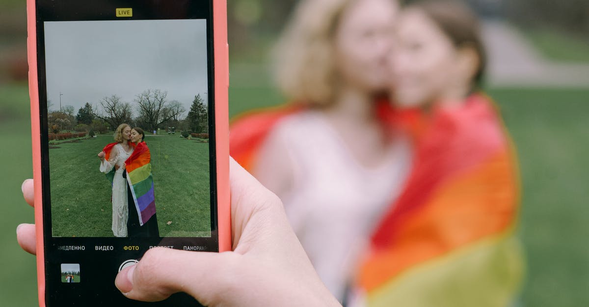 Are there any ways to increase your chances of capturing a Pokemon? - Hand Capturing Photo of Couple with Smartphone