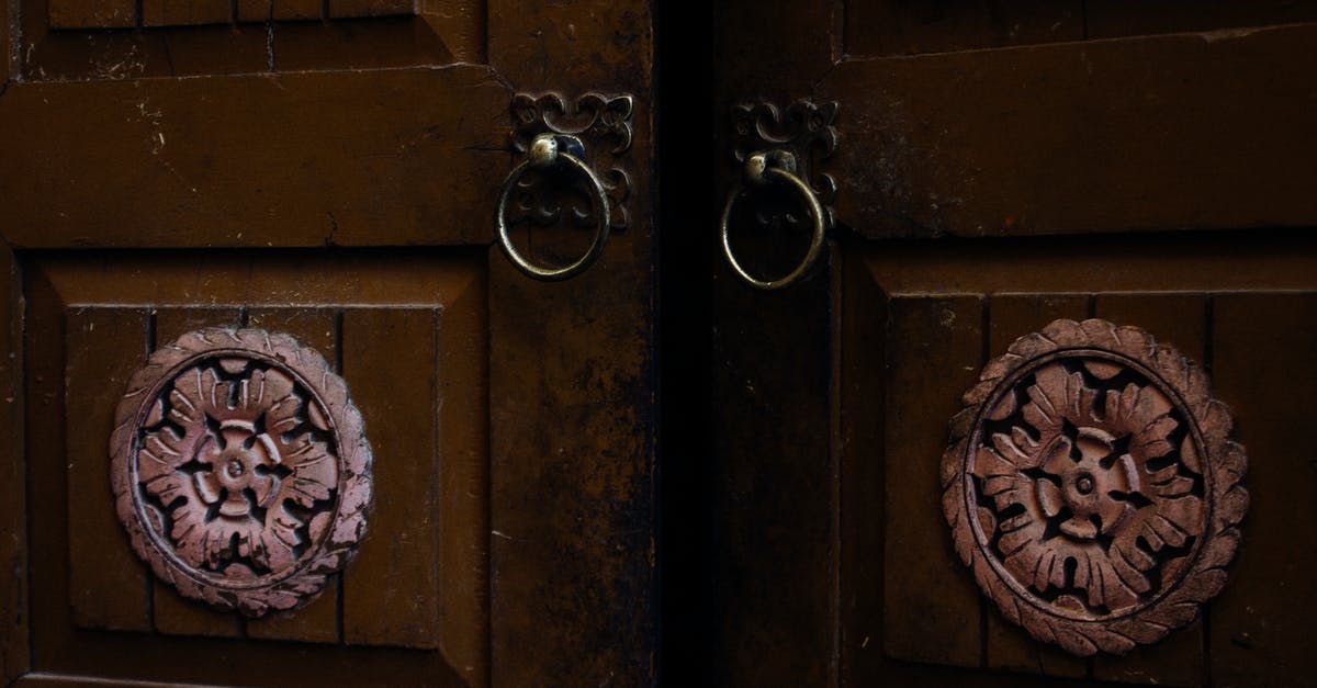 Are there methods to make an Iron Door open through right clicking while holding a specific item? [duplicate] - Old wooden door with ornamental elements and iron door handles