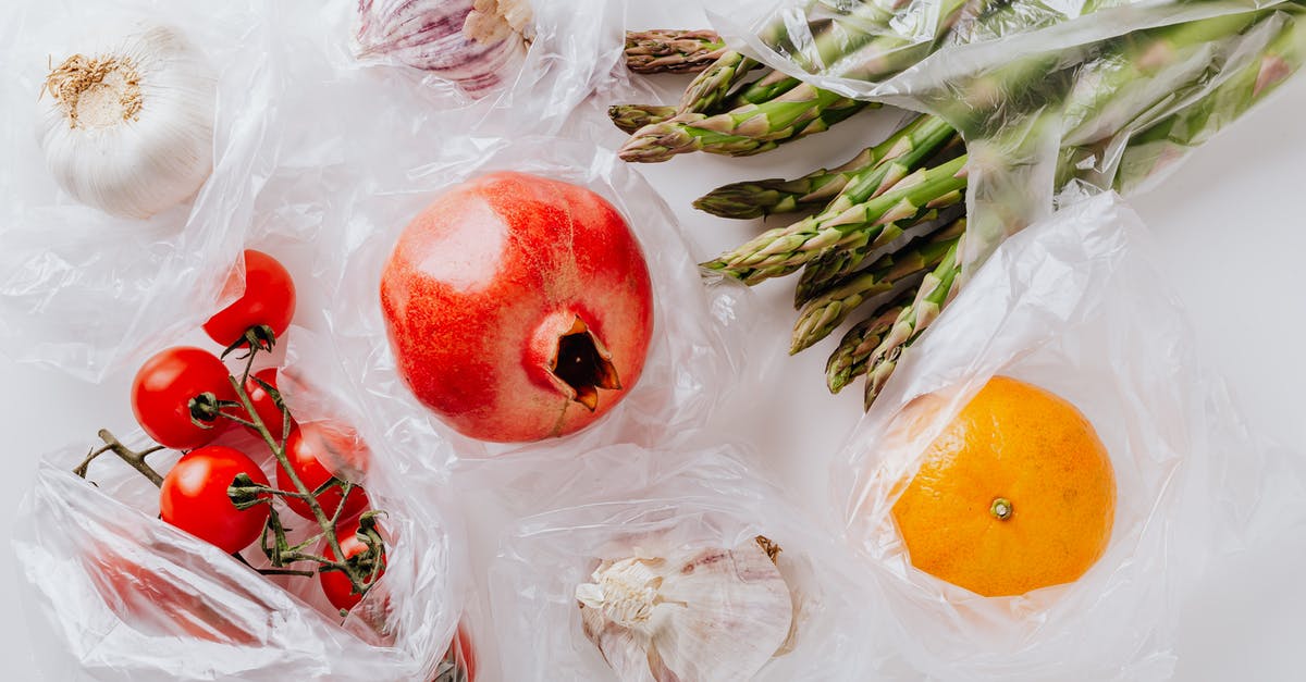 Are there two different cut scenes for every operation head you take out? - Top view of pomegranate in center surrounded by bundle of raw asparagus with orange and bunch of tomatoes put near heads of garlic in plastic bags on white surface